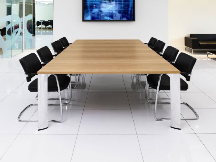 modern conference table with chrome legs and black chairs