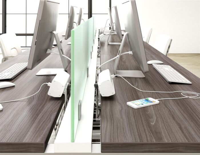 bench desk work space showing panels and computer screens with charge stations