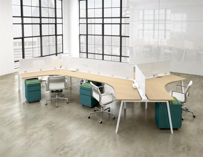 open office bench desking in window filled office