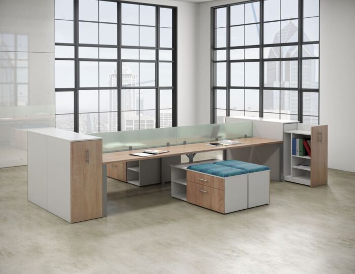 open office bench desking in window filled office