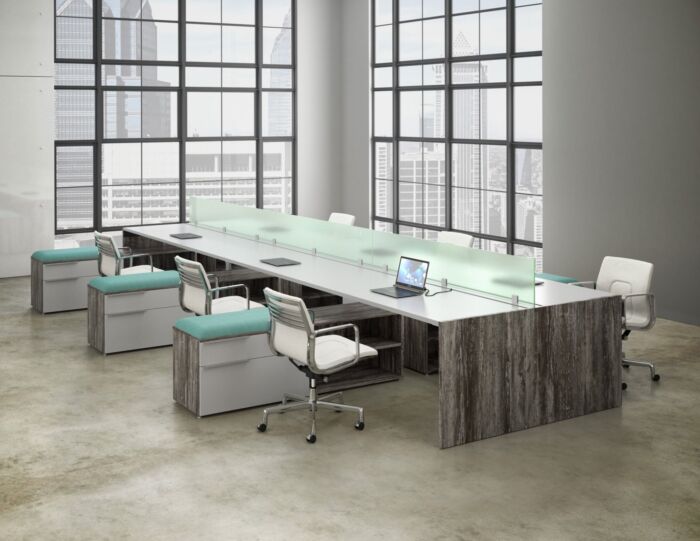 open office bench desking in window filled office