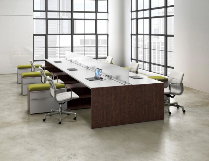 open office bench desking in window filled office