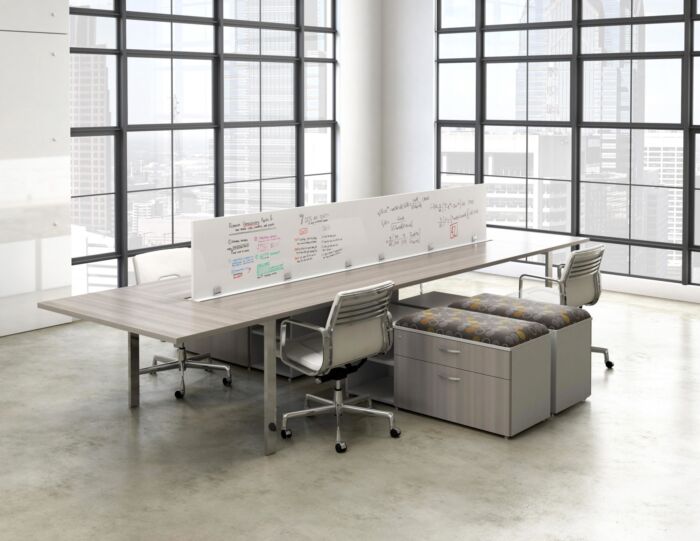 open office bench desking in window filled office