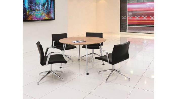 modern table with light wood top and black chairs