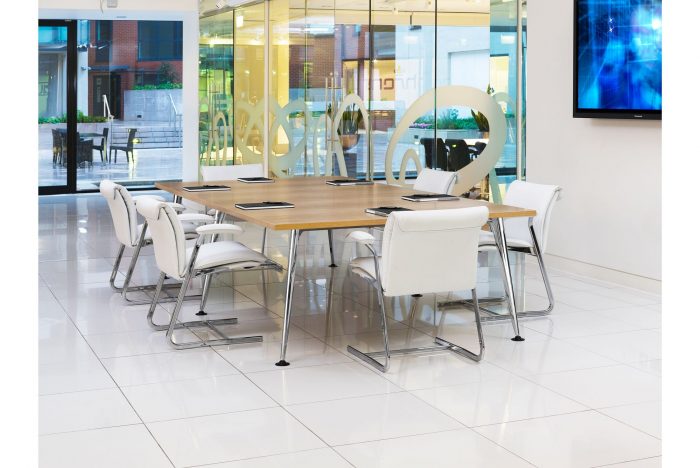 conference table with light wood top and metal legs