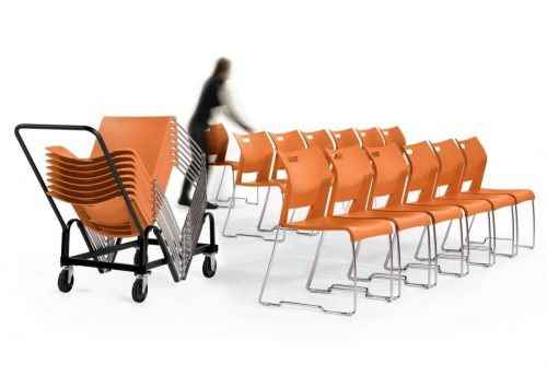 Woman using high-density stacking chair dolly to move orange duet stacking chairs