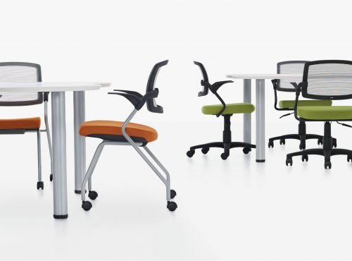 Studio photography of tables with Spritz chairs seated at them.