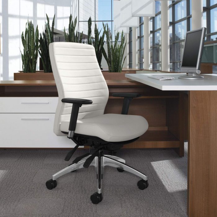 Studio photography of a medium backed Aspen office chair, seated at a wooden workstation.