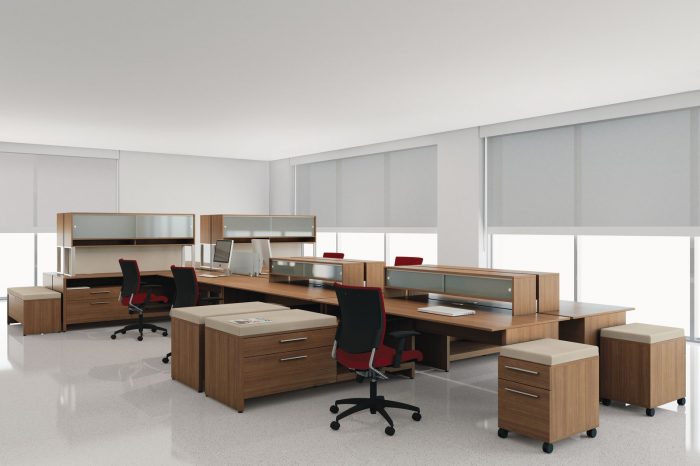 Studio photograph of a corner open-office, with side return credenzas. Seated at each is a red Graphic rolling chair, model 2739.