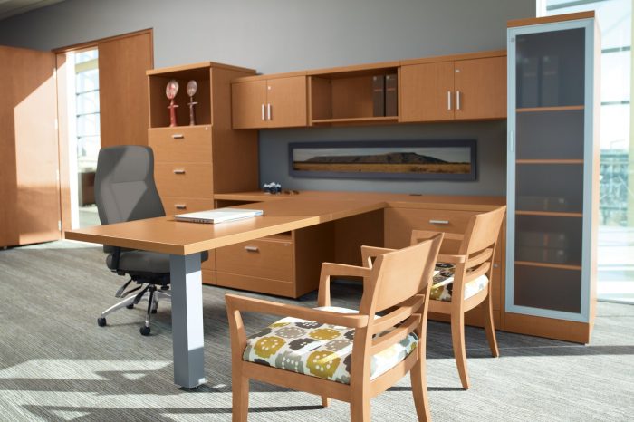 Studio shot inside a small conference area and office. A high backed Triumph chair is placed behind the desk, with two guest chairs in front.
