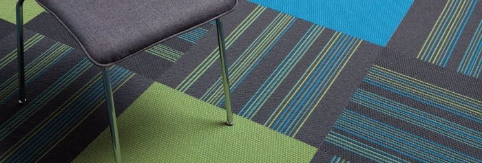 Studio shot of Accelerate Flooring in the classroom. These solid pieces unify the pattern of the other tiles.