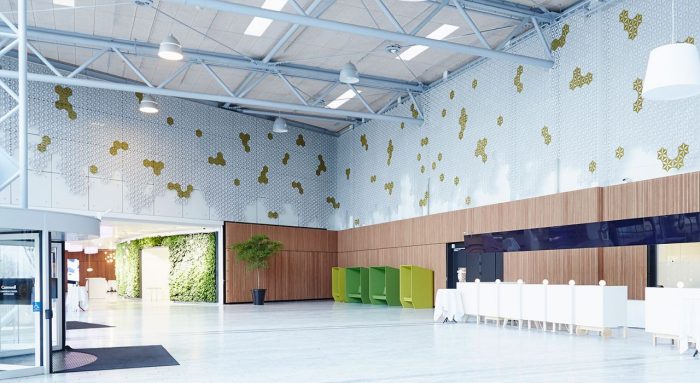 Wide shot inside a large lobby, with Airflake acoustics placed along the upper part of each wall. The studio is hosting other partitions and seating for later display.