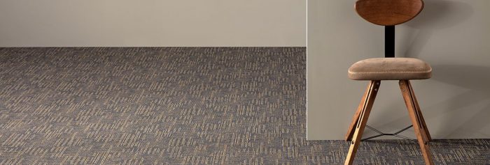 Studio shot looking into two rooms, using City Blocks II model carpeting. A wooden chair is placed against the wall.