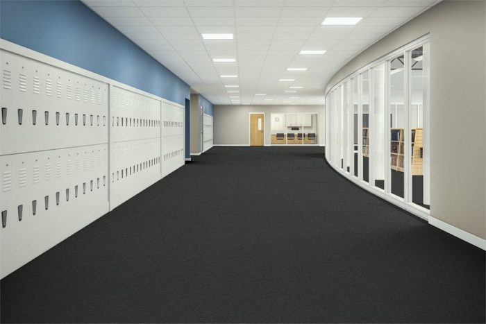Passages 26 carpeted education corridor. Tall windows look into a library, just opposite of the lockers.