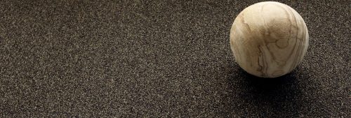 Close up photo of a spherical sculpture resting on Passages carpeting.