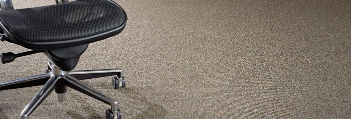 Studio shot of a Structure carpeting, with a rolling chair placed on one side.