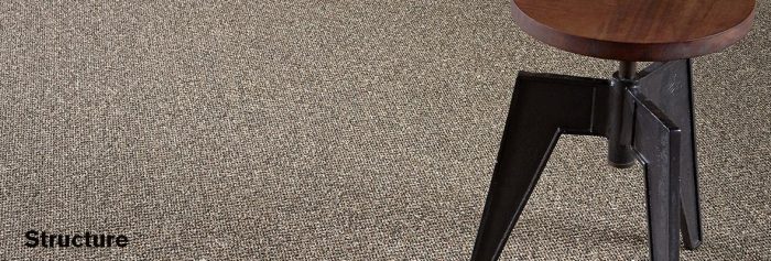Studio shot of a Structure carpeting, with a round stool placed at one side.