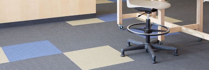Studio shot of Accelerate flooring. There is a mix of color in the carpet pieces.