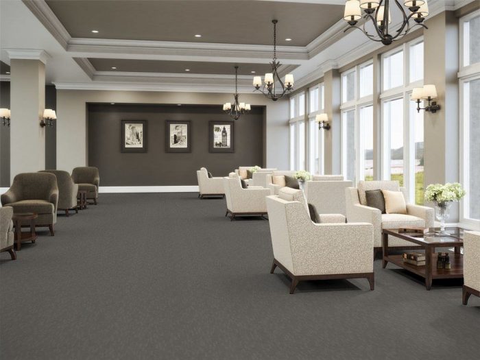 Tone flooring in a common area of the senior center. Tall windows on one side bring light in from outside.