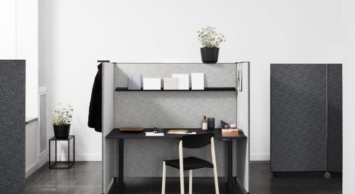 Studio shot of dB screening on a single workstation, and some surrounding partitions. A small chair is pulled up to the workstation, with contrasting light grey dB paneling.
